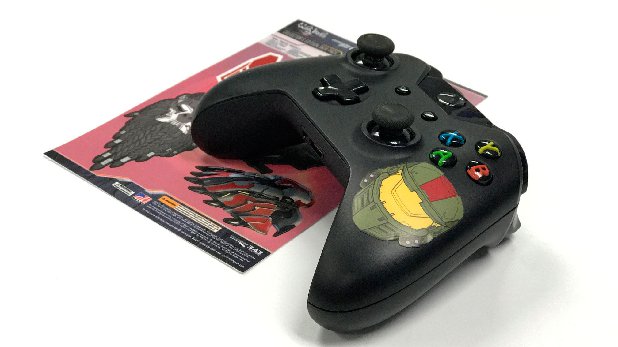 A photo of an Xbox One controller resting on top of the Halo Wars 2 cling sheet. A cling has been applied to the controller.